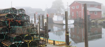 Lobster traps and boats in fog at Fishermans Cove Eastern Passage Halifax Nova Scotia