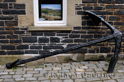 Painting in window and old black anchor in Old Halifax Nova Scotia