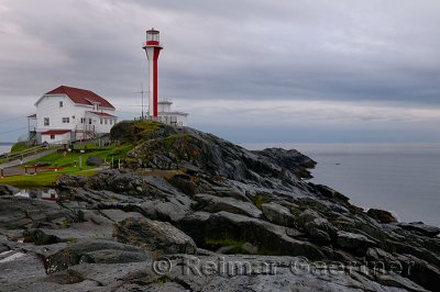 Cape Forchu lighthouse and wet rocks near Yarmouth Nova Scotia