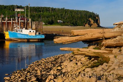 Old dock and Owls Head cliff at sunset on the Bay of Fundy Alma New Brunswick
