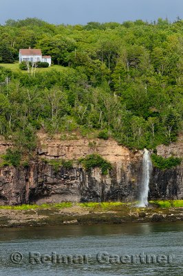 Lone house above waterfalls at Digby Gut on the North Peninsula of Annapois Basin Nova Scotia