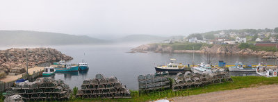 Panorama of lobster traps and fishing boats at Neils Harbour Cape Breton Island Nova Scotia