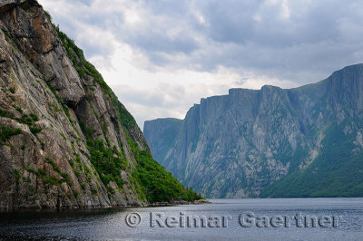 Steep towering Igneous rock walls at Western Brook Pond inland fjord at Gros Morne National Park Newfoundland