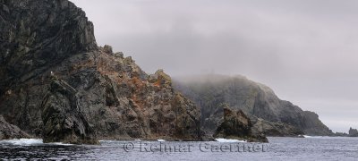 Panorama of rough cliff and spires at Devil`s Cove Head and Long Point Lighthouse Twillingate Newfoundland
