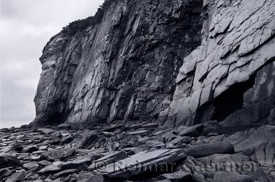Black and white image of sheer rock cliff face at Cape Enrage New Brunswick