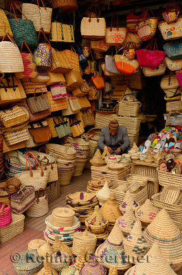 Shopkeeper selling basket weaving bags and containers in Casablanca new outdoor market