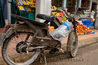 Old motorbike parked at grocery store in the outdoor Casablanca new market