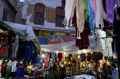 Crowded labyrinth and clothing shopkeepers in the old Medina of Casablanca