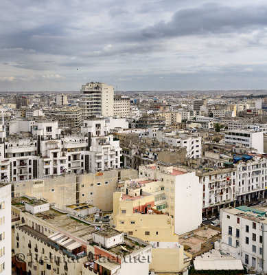 Daytime view of the white Casablanca cityscape with clouds