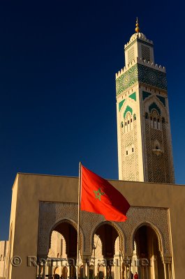 Moroccan flag at the Hassan II Mosque in Casablanca with blue sky