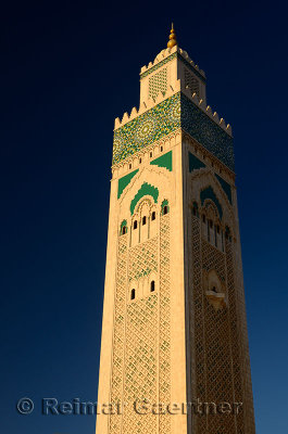 Worlds tallest minaret of the Hassan II Mosque in Casablanca Morocco at sunset