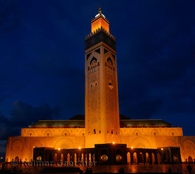 Golden lights on Hassan II Mosque and minaret at night in Casablanca Morocco