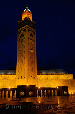 Gold artificial lights on Hassan II Mosque and minaret at night in Casablanca Morocco