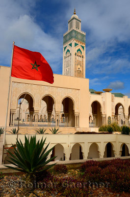 Moroccan flag and gardens at the Hassan II Mosque in Casablanca Morocco