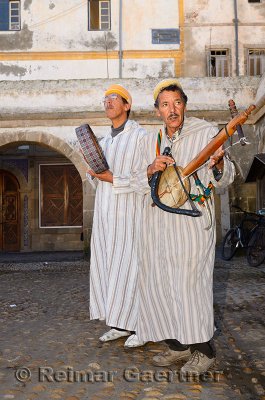 Street musicians playing folk music on rabab fiddle and bendir hand drum in Essaouira Morocco