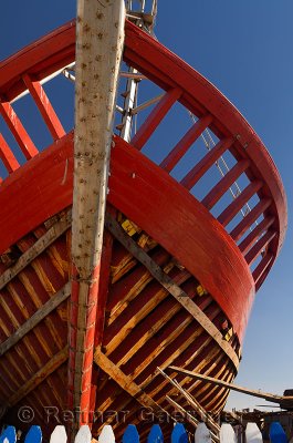 Red wooden boat under construction at the Essaouira Port in Morocco
