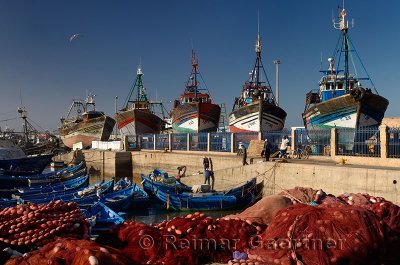 Red nets and fishermen getting ready to sail in the morning at the marine port of Essaouira Morocco