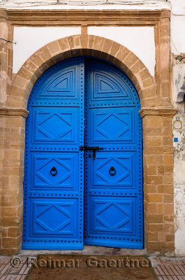 Fresh painted blue door with stonework at Riad Al Madina in Essaouira Morocco