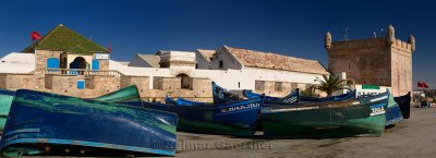 Panorama of blue and green fishing boats for sale at Sqala du Port Essaouira Morocco