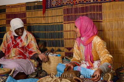 Two Moroccan women at the Afous Argane womens cooperative cracking argan kernels