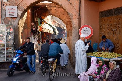 Traffic from the Djemaa el Fna square to shops in the narrow souk of Marrakech Morocco