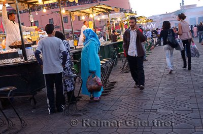Snail snack stall vendors calling out to beautiful women walking in Djemaa el Fna square Marrakech