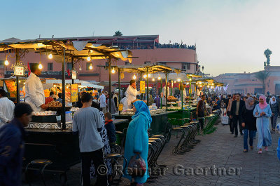 Crowds at the snail snack stall vendors in Place Djemaa el Fna square Marrakech Morocco
