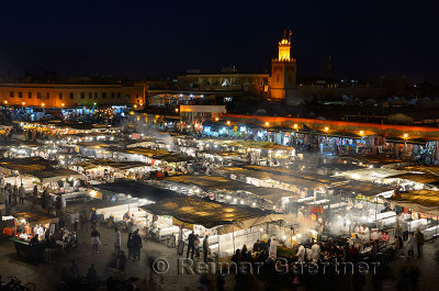 Crowds at the food vendors at night in Place Djemaa el Fna square Marrakech Morocco