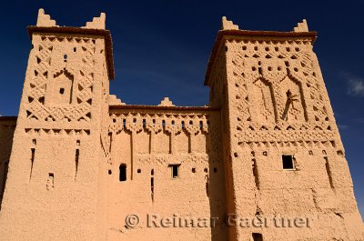 Rooftop towers of Kasbah Amerhidil against a blue sky in the Skoura oasis Morocco