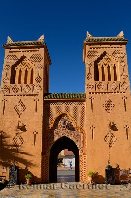 Traditional Berber pise towers made of red adobe and blue sky at desert resort