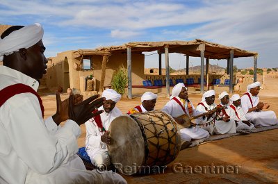 Pigeons du Sable Gnawa musici group in white turbans and jellabas playing in Khemliya Morocco