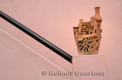 Ceramic pottery sculpted as a Kasbah on the railing of a stairway in Fes Morocco