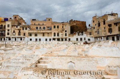 Rows of white tombs in the Mellah Jewish cemetery on a cloudy day in Fes Morocco