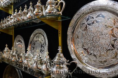 Metalware shop with silver teapots and plates with intricate design engraving Fes Morocco