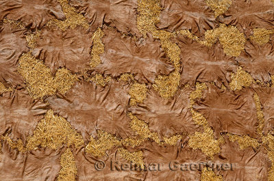 Abstract of processed tanned hides drying on straw in the sun in el Bali Medina Fes Morocco