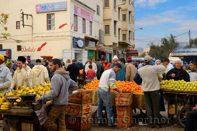 Crowds at fruit stands in the el Bali Medina souk market of Fes Morocco