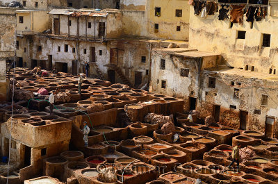 White mineral tanning vats and brown vegetable soaking pits in the Fes tannery Morocco