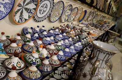 Brightly colored tagine bowls and plates in a ceramic shop in Fes el Bali Medina Morocco