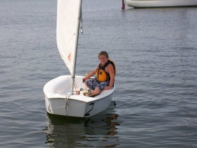 Ethan in beamy catboat at sailing camp