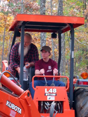 Showing Jonah how to operate the new tractor