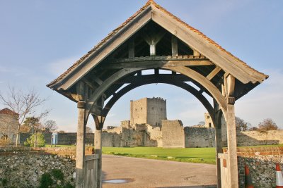 Portchester Castle through the gate of St Marys Church.