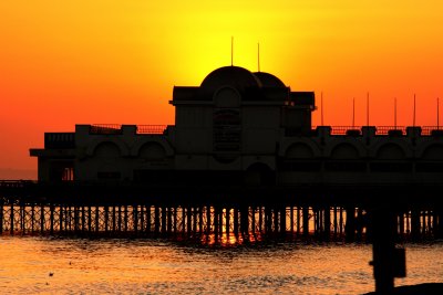 The sun sets behind Southsea pier.