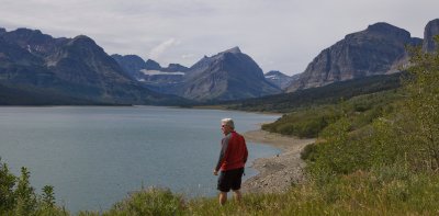 Looking west across a lake at Many Glacier. That's Steve looking for gold.