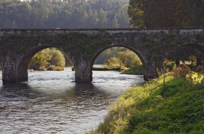 Ten-arch rubble stone classical-style road bridge over river Nore