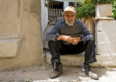 Sitting in front of his house