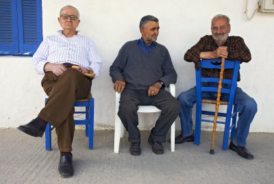 Three men sitting on a chair