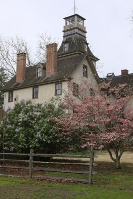 Lilacs and dogwood set off the mansion.