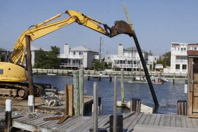 14.  Positioning it to lie on the barge.