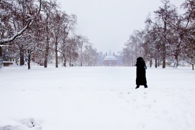 7.  A lone visitor crosses the Palace Green, the palace visible in the background.