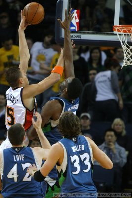 Golden State Warriors center Andris Biedrins scores over Minnesota Timberwolves center Al Jefferson